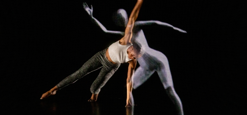A Kennesaw State University dance student and the LuminAI-powered avatar dance together.