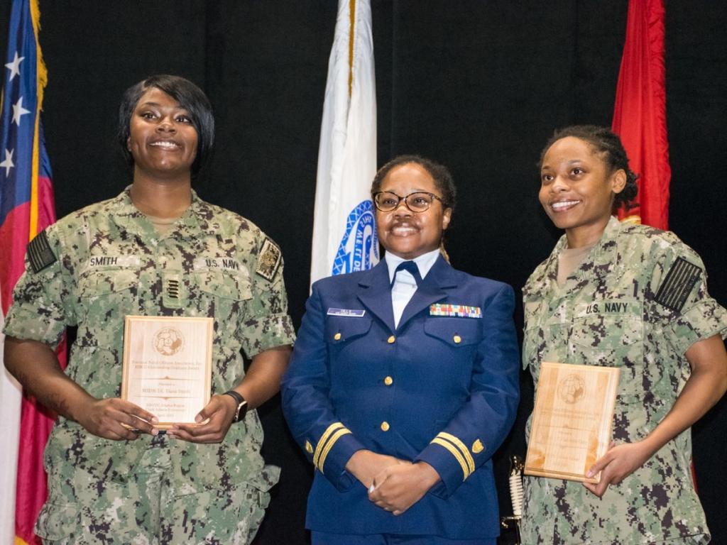 two rotc students pose on stage with their awards