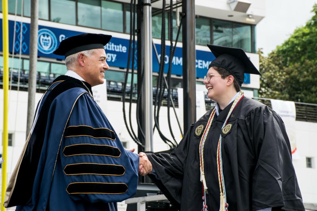 IAC student shaking hands with President Cabrera at commencement
