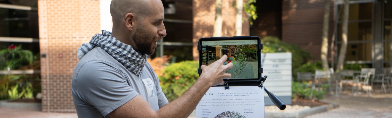 Yanni Loukissas presents his augmented reality research project on a tablet.