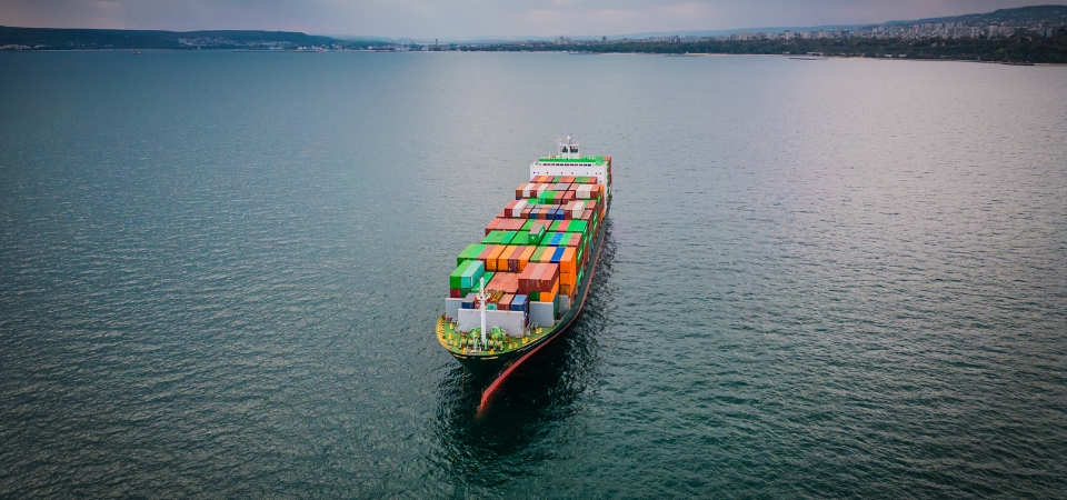 A loaded container ship in the sea, aerial view