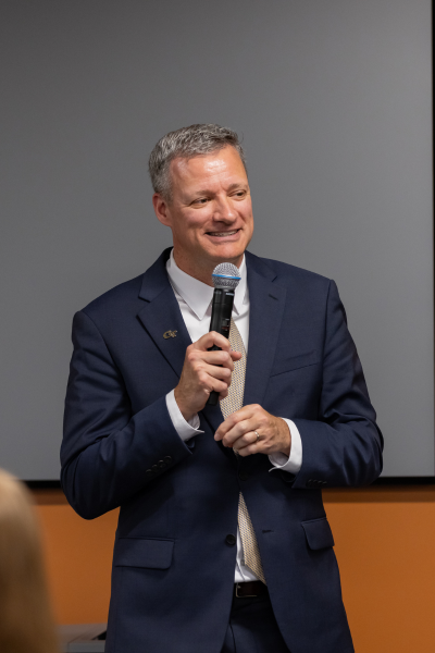 A speaker talks into a microphone