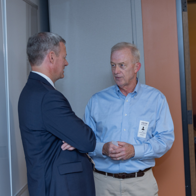 faculty members chat after the panel discussion