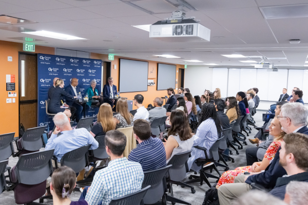 Panelists Ellen Bassett, Richard Utz, Devesh Ranjan, Cassidy Sugimoto, and Dene Sheheane speak in front of a room full of GTDC students and Georgia Tech faculty.