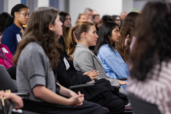 Members of the audience listen to the panel.