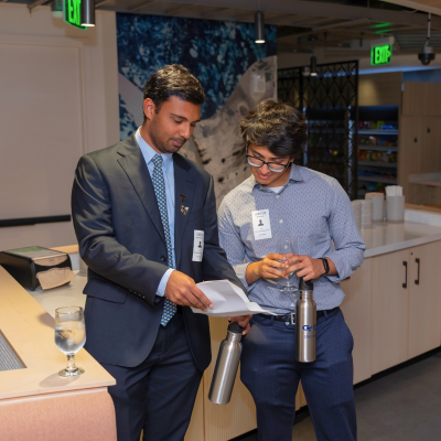 Two students look at a document.