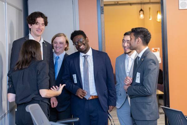 Students socialize after the panel discussion.