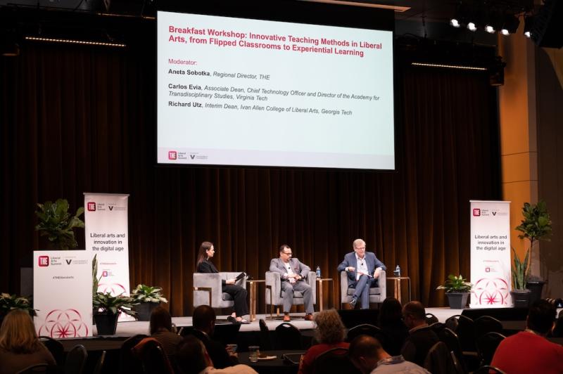 Interim Dean Richard Utz onstage at the Liberal Arts Symposium. A slide above the presenters reads "Breakfast Workshop: Innovative Teaching Methods in Liberal Arts, from Flipped Classrooms to Experiential Learning"