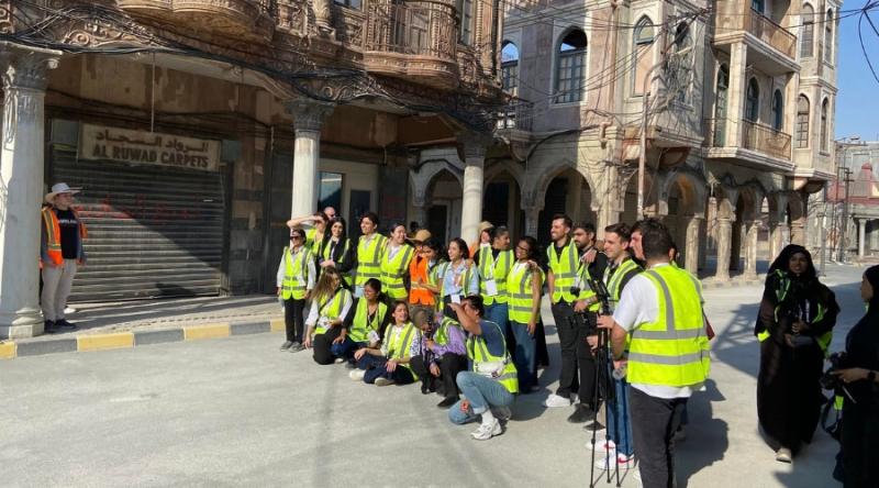 Group of students in yellow vests at the CNN simulation