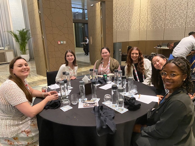 students smiling at a dinner table