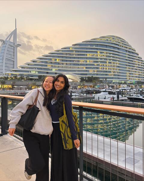 two students posing outside in front of the burj al arab building