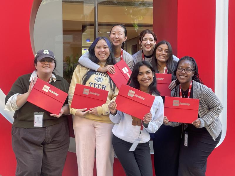 group photo holding red CNN certificates