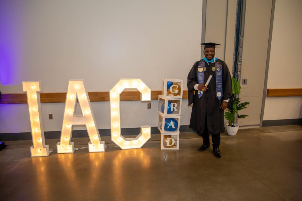 posing with IAC sign post ceremony