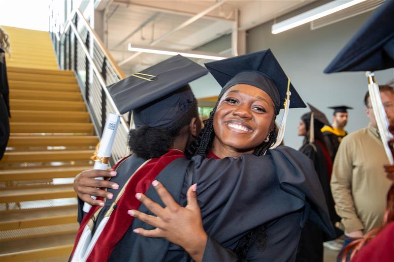 grads hugging after ceremony