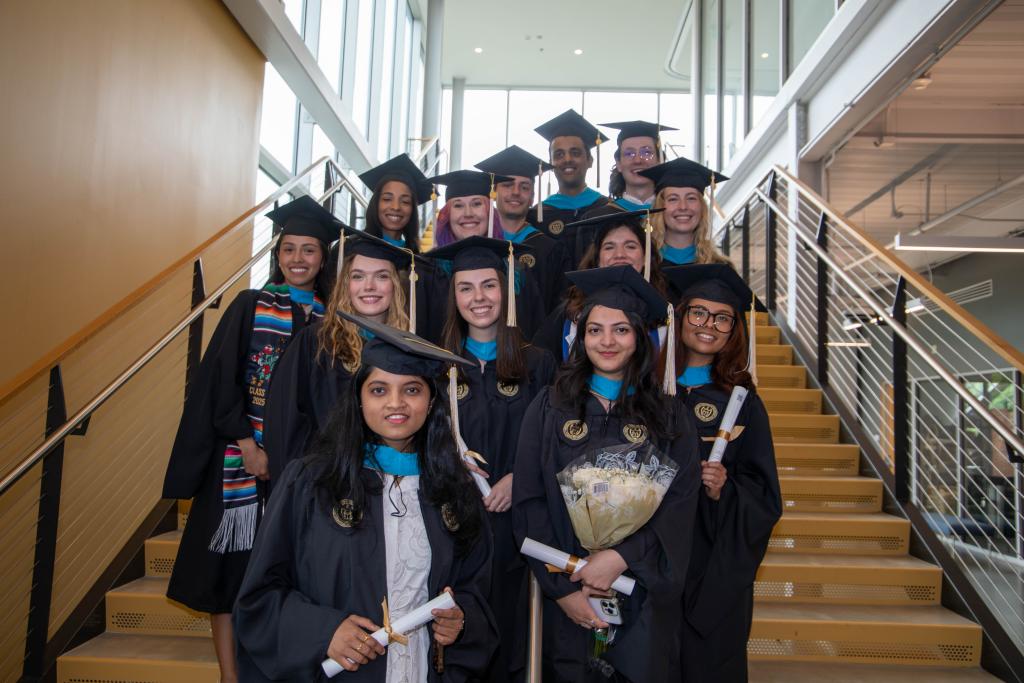 grads posing together after ceremony