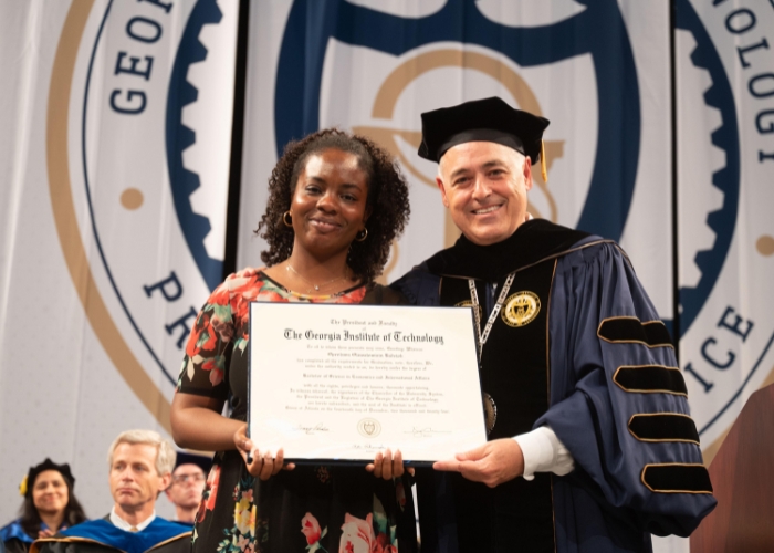 Cabrera presenting degree to the mother of a student who passed away