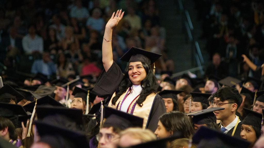 grad waving in crowd