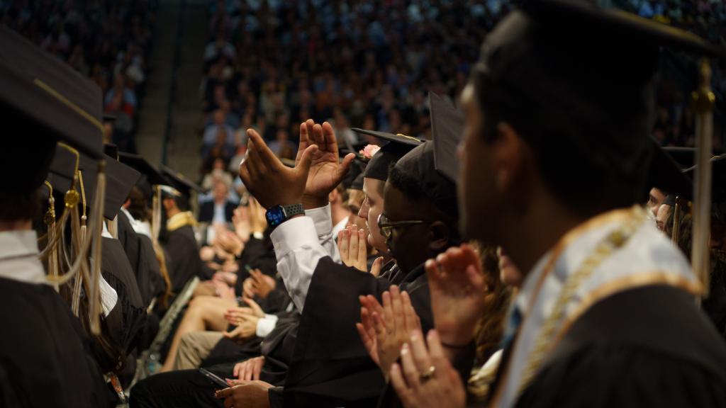 grads clapping in the audience