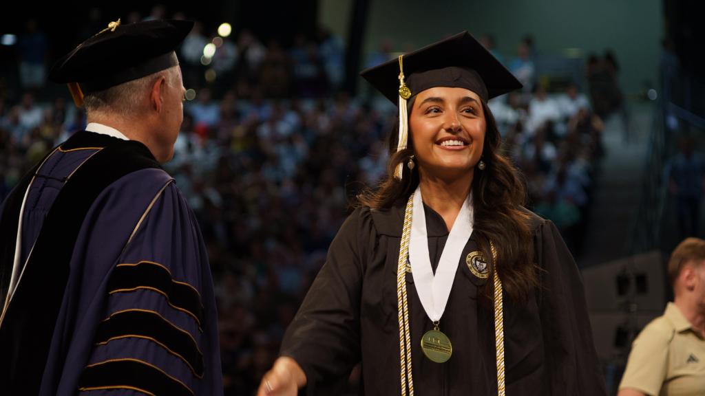 student receiving their diploma from Cabrera