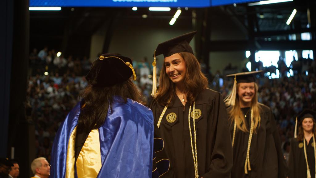students in line to receive diploma