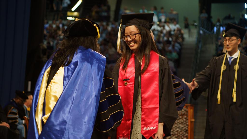 students in line to receive diploma