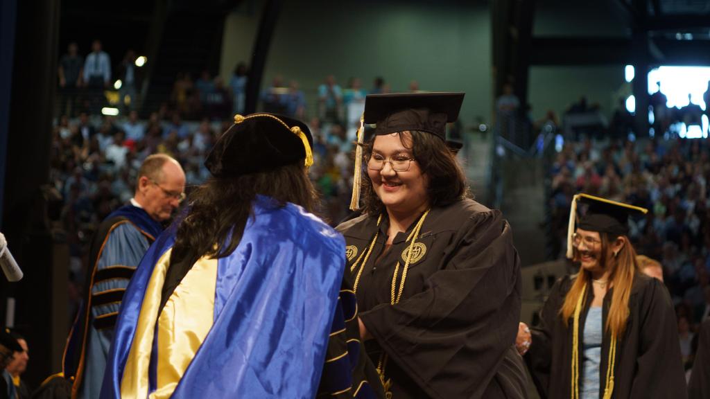 students in line to receive diploma