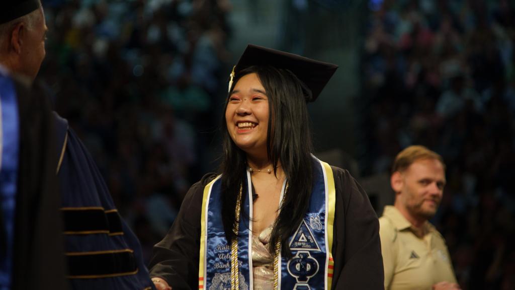 student receiving their diploma from Cabrera
