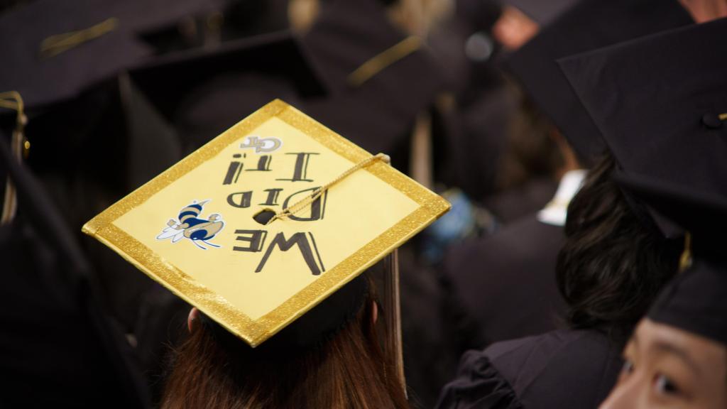 grad cap saying "we did it"