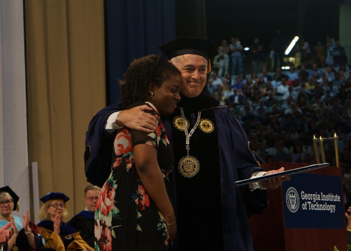 Cabrera presenting degree to the mother of a student who passed away