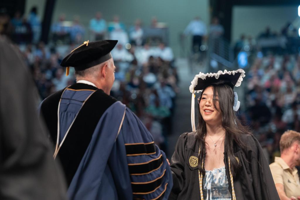 student receiving their diploma from Cabrera