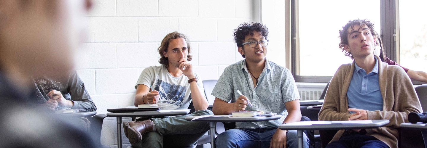 Students engaging in classroom with pencils at the ready.