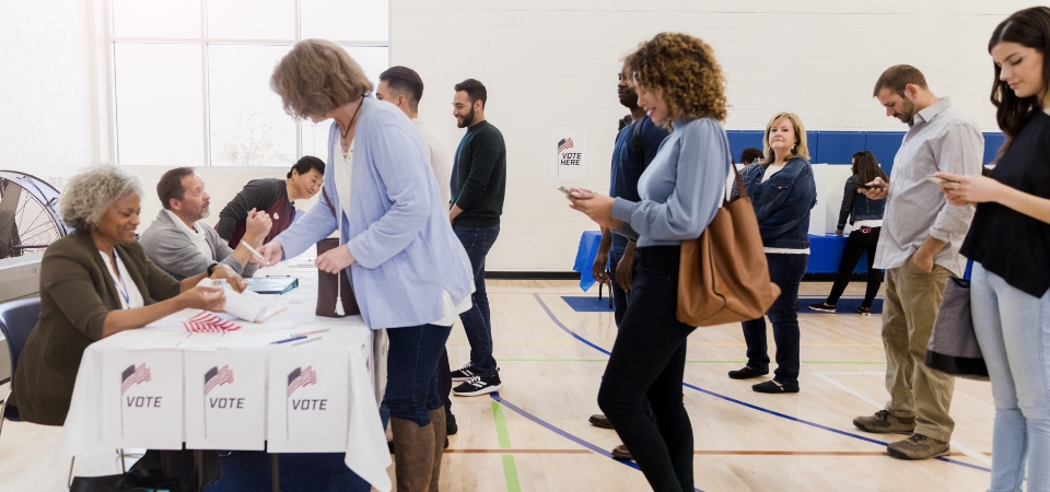 People standing in line at voting center.