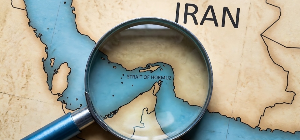 Map of Iran with a magnifying glass over the Strait of Hormuz.