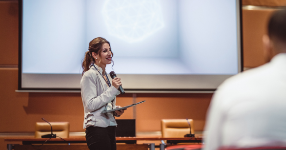 Woman speaking in front of a crowd