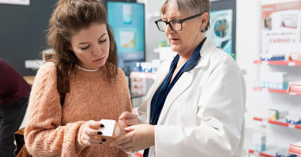 Woman and doctor discussing medicine at a pharmacy