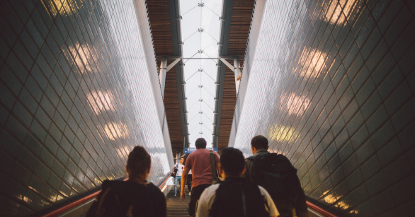 People walking out through a subway system elevator