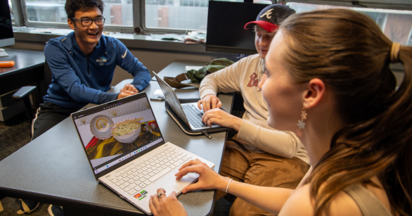 Students in an LMC class working together and creating digital art 