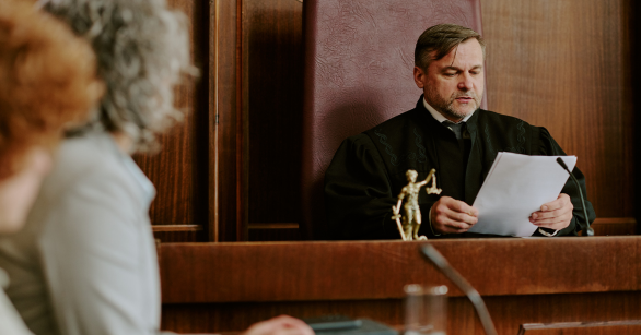 judge reading a document in a courtroom