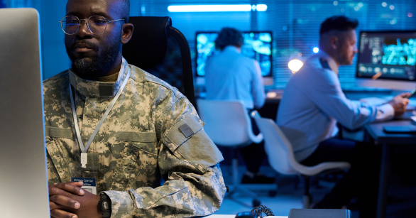 Military command center with soldiers working on computers