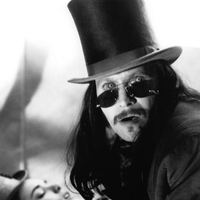 Actor Gary Oldman in a top hat and dark glasses