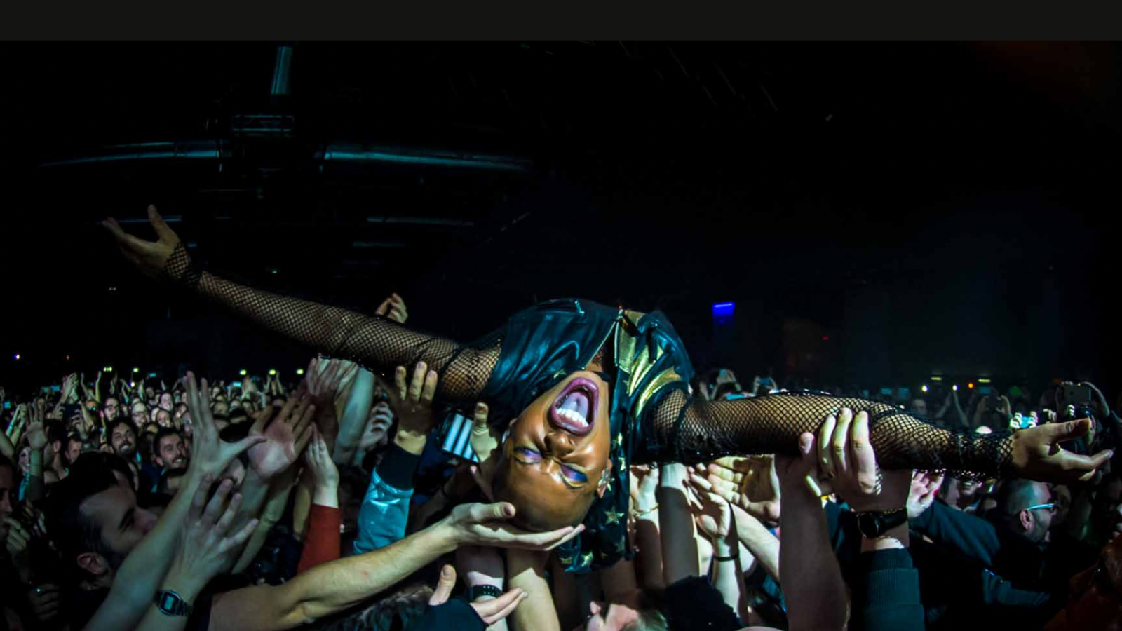 image of a political rocker Skin crowdsurfing at a show