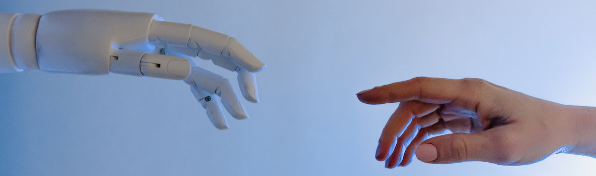a robot hand reaches out to a human hand