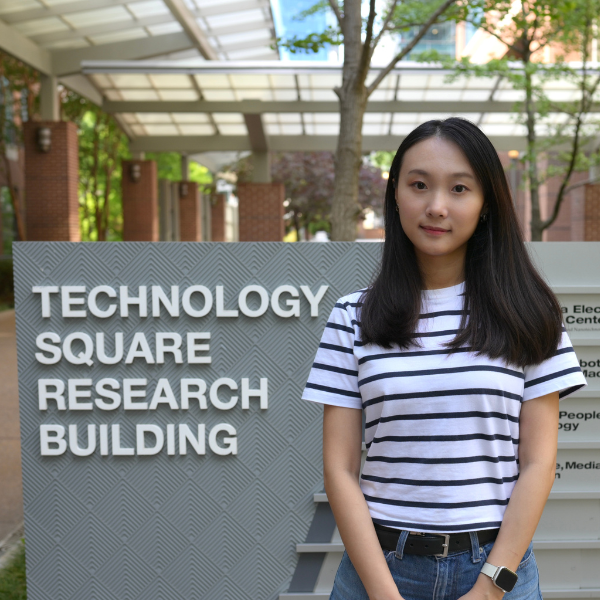 Shi Ding in front of her research building