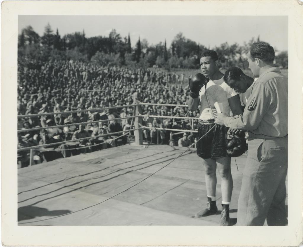 Joe Louis speaking at an army exhibition match during World War II.