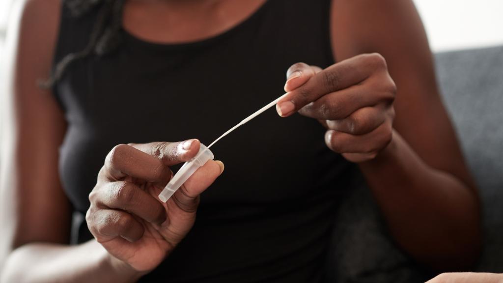 A woman holds an at-home Covid-19 test.