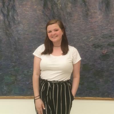 Kailey Nelson in front of a painting